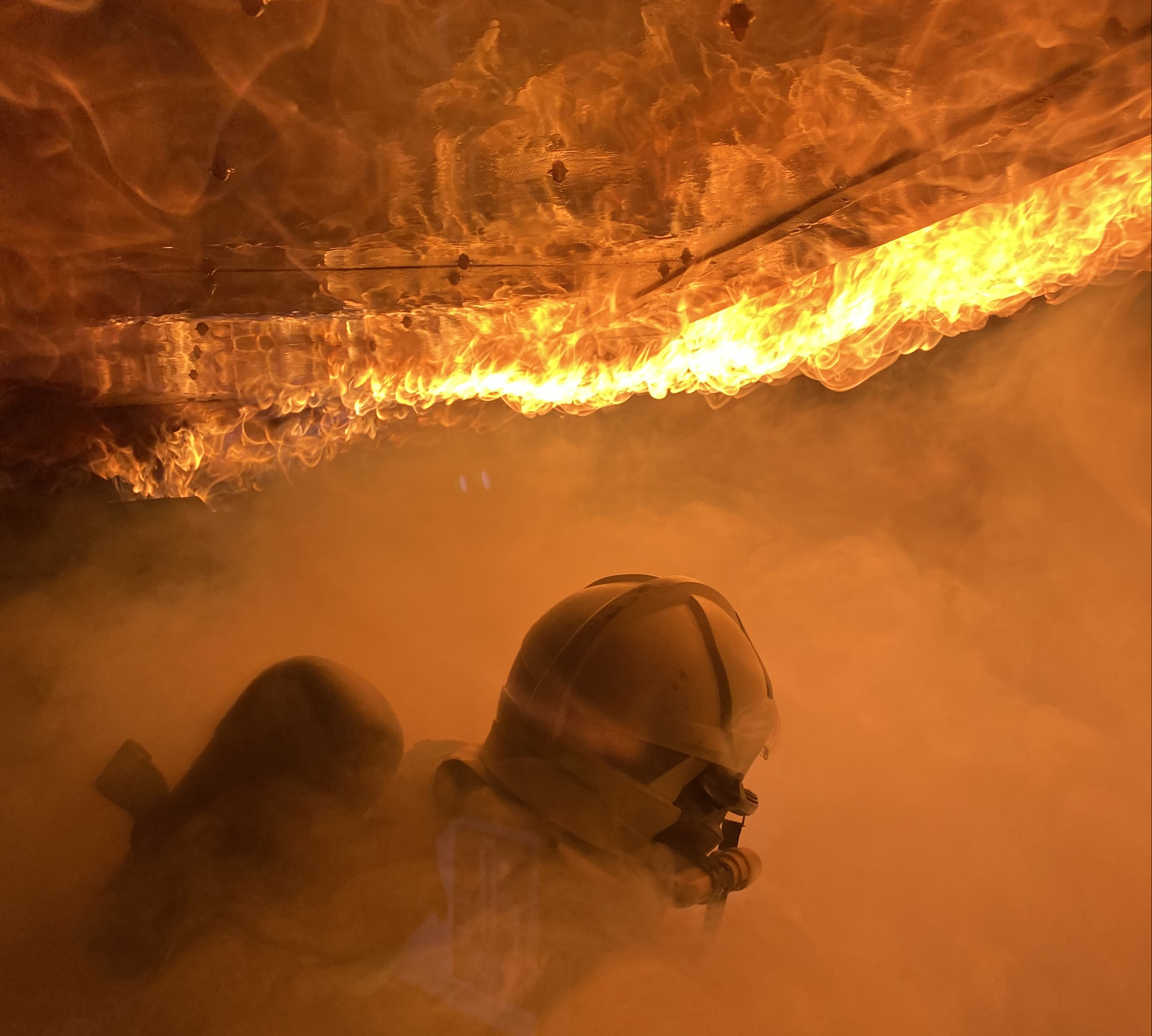 Ein Feuerwehrmann in einem brennenden Haus
